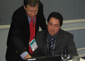 DCRI faculty Chris Granger and Renato Lopes discuss their research during an investigator meeting during AHA 2007.
