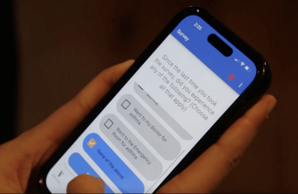 Olivia holding a mobile phone