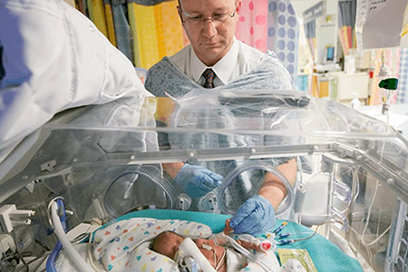 Dr. Brian Smith treats a newborn patient in the Duke Neonatal Intensive Care Unit.