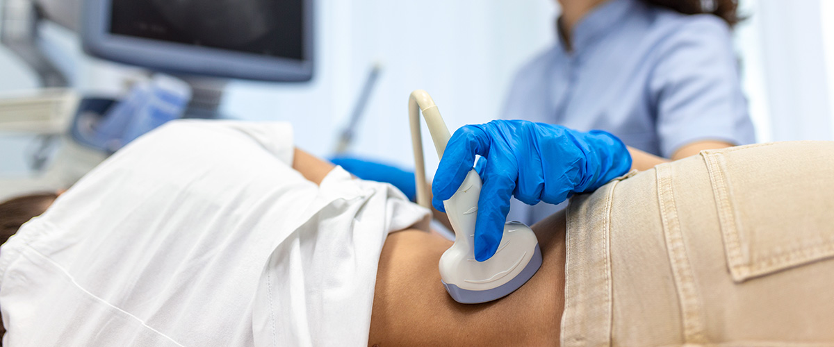 Nurse conducts ultrasound examination of patient's kidneys