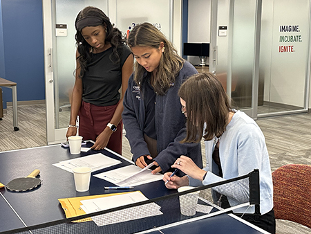 STAR program participants collaborate on a group exercise, reviewing materials and discussing ideas during a workshop session in a team-oriented learning environment.
