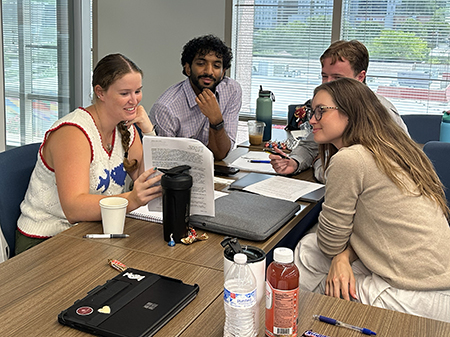 STAR program participants work together in a small-group activity, reviewing materials and exchanging ideas during a collaborative workshop session.