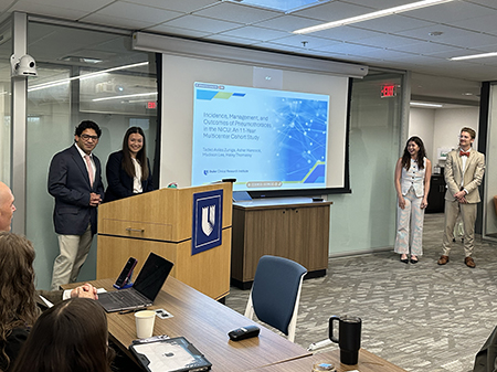 Presenters share research findings during a STAR program educational session, speaking to attendees gathered in a conference room as presentation slides are displayed on a projection screen.