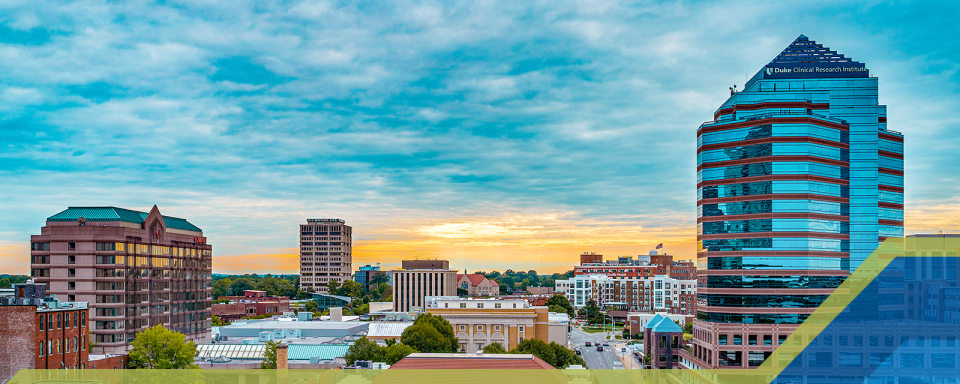 The Durham Centre, the office building where the DCRI is housed, is shown set against a sunset sky. Durham Centre photo credit: Discover Durham