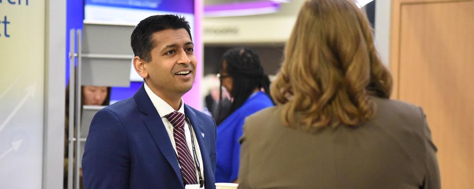 DCRI faculty member Nishant Shah speaks with a colleague at a conference.